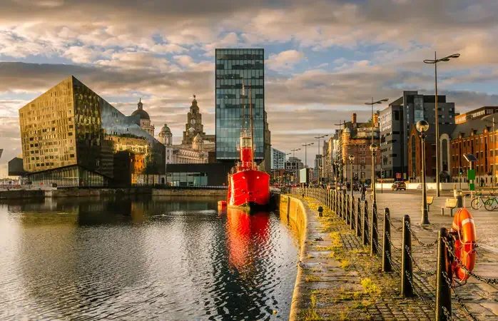 Liverpool's historic waterfront with modern and old architecture at sunset