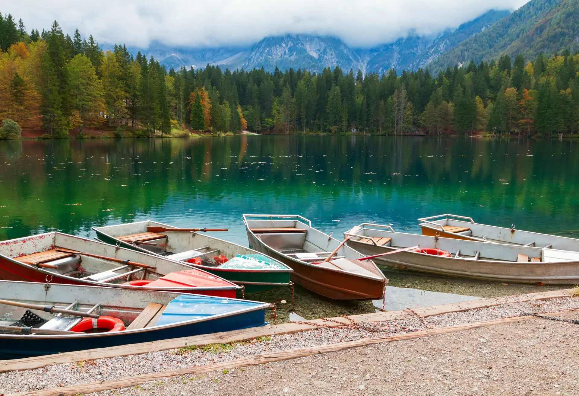 Beautiful Lago di Fusine the mountain lake at boat and Mangart mountain in the background in north Italy in Alps, Europe; Shutterstock ID 591412892; Purpose: CITY; Brand (KAYAK, Momondo, Any): KAYAK